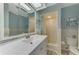 Bright bathroom featuring a shower, vanity, and a mirrored medicine cabinet at 1915 Illinois Ave, Englewood, FL 34224