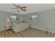 Inviting bedroom with two windows showcasing neighborhood views and matching side tables at 1915 Illinois Ave, Englewood, FL 34224