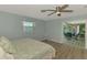 Comfortable bedroom features a ceiling fan and bright natural light from the window at 1915 Illinois Ave, Englewood, FL 34224