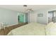 Cozy bedroom with a closet and ceiling fan showcases easy access to an additional space at 1915 Illinois Ave, Englewood, FL 34224