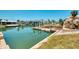 Waterfront canal view with a dock and lush landscaping surrounding the property at 1915 Illinois Ave, Englewood, FL 34224