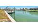 Scenic view of canal with dock, seawall, and lush greenery surrounding waterfront property at 1915 Illinois Ave, Englewood, FL 34224