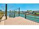 Waterfront canal view from a wooden dock equipped with boat lift and railings on a sunny day at 1915 Illinois Ave, Englewood, FL 34224