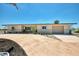 Home exterior with a well-manicured lawn, palm trees, and a spacious driveway at 1915 Illinois Ave, Englewood, FL 34224