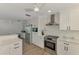 Well-equipped kitchen with stainless steel appliances, white cabinetry, ample counter space, and modern fixtures for a sleek look at 1915 Illinois Ave, Englewood, FL 34224