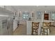 Beautiful modern kitchen with white cabinets, stainless steel appliances, and a breakfast bar with seating for a functional layout at 1915 Illinois Ave, Englewood, FL 34224