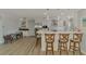 Open-concept kitchen with bar seating and stainless steel appliances at 1915 Illinois Ave, Englewood, FL 34224