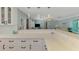 Open-concept kitchen with quartz countertops, white cabinets, subway tile backsplash, and views into the adjacent living space at 1915 Illinois Ave, Englewood, FL 34224