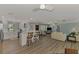 Bright open floor plan showcasing the modern kitchen and living area with light, neutral decor and wood-look flooring at 1915 Illinois Ave, Englewood, FL 34224