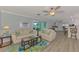 Inviting living room featuring wood floors, ceiling fan and comfortable seating at 1915 Illinois Ave, Englewood, FL 34224