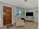 Comfortable living room with wood floors, modern TV and a view of the neighborhood at 1915 Illinois Ave, Englewood, FL 34224