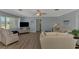 Cozy living room featuring a comfortable sofa, accent chair, and a large window for natural light, creating a welcoming atmosphere at 1915 Illinois Ave, Englewood, FL 34224