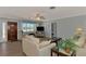 Relaxing living room featuring a stylish sofa, entertainment center with a TV, and a large window showcasing the outdoor view at 1915 Illinois Ave, Englewood, FL 34224