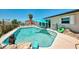 Inviting pool with a built-in rock feature and ample space for lounging at 1915 Illinois Ave, Englewood, FL 34224