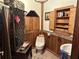 Bathroom with wood paneled walls and cabinetry at 1916 Myrtle Ave, Punta Gorda, FL 33950