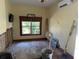 Bedroom with a window offering natural light and unfinished hardwood flooring at 1916 Myrtle Ave, Punta Gorda, FL 33950