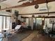 Spacious living room with exposed beams, stone accent wall, and sliding doors at 1916 Myrtle Ave, Punta Gorda, FL 33950