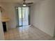Bright dining area with a ceiling fan and sliding doors leading to a screened-in porch at 194 Garden Nw Ave, Port Charlotte, FL 33952