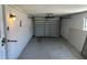 A single car garage featuring a light, garage door, and concrete floor at 194 Garden Nw Ave, Port Charlotte, FL 33952
