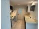 Efficient kitchen featuring white appliances, tile floor, and contrasting black and white cabinets at 194 Garden Nw Ave, Port Charlotte, FL 33952
