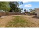 Large backyard featuring mature trees, partial fencing, a chicken coop and a fire pit at 21070 Gertrude Ave, Port Charlotte, FL 33952