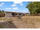 Spacious backyard featuring a fire pit, partial fencing, bamboo, and a shade sail at 21070 Gertrude Ave, Port Charlotte, FL 33952