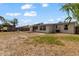 Spacious backyard featuring a fire pit, partial fencing, bamboo, and a shade sail at 21070 Gertrude Ave, Port Charlotte, FL 33952