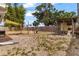 Large backyard features fire pit, chicken coop, mature trees, and an outdoor canopy at 21070 Gertrude Ave, Port Charlotte, FL 33952