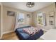 Bedroom featuring hardwood floors, cream walls, a ceiling fan and two windows allowing for ample sunlight at 21070 Gertrude Ave, Port Charlotte, FL 33952