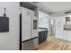 Bright kitchen showcasing stainless steel refrigerator and wooden floors at 21070 Gertrude Ave, Port Charlotte, FL 33952