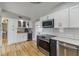 Well-lit kitchen featuring white cabinets, stainless steel appliances, and stylish countertops at 21070 Gertrude Ave, Port Charlotte, FL 33952