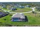 An aerial view of the property and neighboring homes, highlighting the community's spacious layout and serene atmosphere at 27 Tee View Rd, Rotonda West, FL 33947