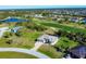 Gorgeous aerial shot of homes with golf course and water views, emphasizing the property's prime location in a tranquil setting at 27 Tee View Rd, Rotonda West, FL 33947