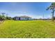 Lush, green backyard showcasing ample space and a screened-in patio, offering a serene outdoor living area at 27 Tee View Rd, Rotonda West, FL 33947
