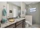 Well-appointed bathroom featuring a marble countertop vanity, a toilet, and a walk-in shower with tile surround at 27 Tee View Rd, Rotonda West, FL 33947