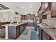 Modern kitchen with stainless appliances, subway tile backsplash, and an island with marble countertops at 27 Tee View Rd, Rotonda West, FL 33947