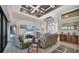 Spacious living room with high ceilings, unique ceiling details, and ample natural light, perfect for entertaining at 27 Tee View Rd, Rotonda West, FL 33947