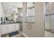 This luxurious main bathroom has tiled shower with bench, double vanity, and decorator mirror at 27 Tee View Rd, Rotonda West, FL 33947