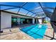 Beautiful pool featuring a screened-in enclosure and sunny patio for outdoor living and refreshing relaxation at 27 Tee View Rd, Rotonda West, FL 33947