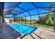 Inviting screened-in pool surrounded by a paved deck, offering a refreshing and private outdoor oasis at 27 Tee View Rd, Rotonda West, FL 33947
