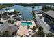 Gorgeous aerial view of the community, the waterfront, boat docks, and the inviting pool at 2769 N Beach Rd # 205, Englewood, FL 34223