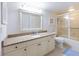 Well-lit bathroom with granite countertop, sink, toilet, vanity, and glass-enclosed shower at 2769 N Beach Rd # 205, Englewood, FL 34223