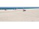 Expansive sandy beach with clear blue water and people enjoying recreational activities at 2769 N Beach Rd # 205, Englewood, FL 34223