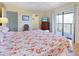 Bright bedroom with balcony access and a view, features closet and ensuite bathroom at 2769 N Beach Rd # 205, Englewood, FL 34223