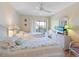 Charming bedroom features twin beds, wicker furniture, a ceiling fan, and balcony access at 2769 N Beach Rd # 205, Englewood, FL 34223