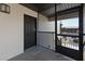 Condo entrance featuring a storm door, black door and railing at 2769 N Beach Rd # 205, Englewood, FL 34223