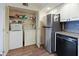Bright kitchen features a convenient washer and dryer closet, and stainless steel appliances for modern living at 2769 N Beach Rd # 205, Englewood, FL 34223