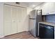Well-organized kitchen with stainless steel appliances and a discreet, fully-enclosed laundry area for efficiency at 2769 N Beach Rd # 205, Englewood, FL 34223