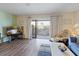 Comfortable living room with sliding glass doors to the balcony, letting in natural light and scenic views at 2769 N Beach Rd # 205, Englewood, FL 34223