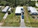 Aerial shot of the property highlighting the house, lawn, and vehicle at 2906 Waterside Dr, Englewood, FL 34224
